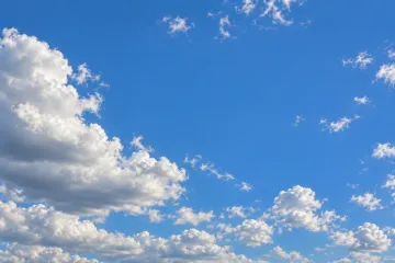 Cumulus cloud against blue sky, mid-afternoon.