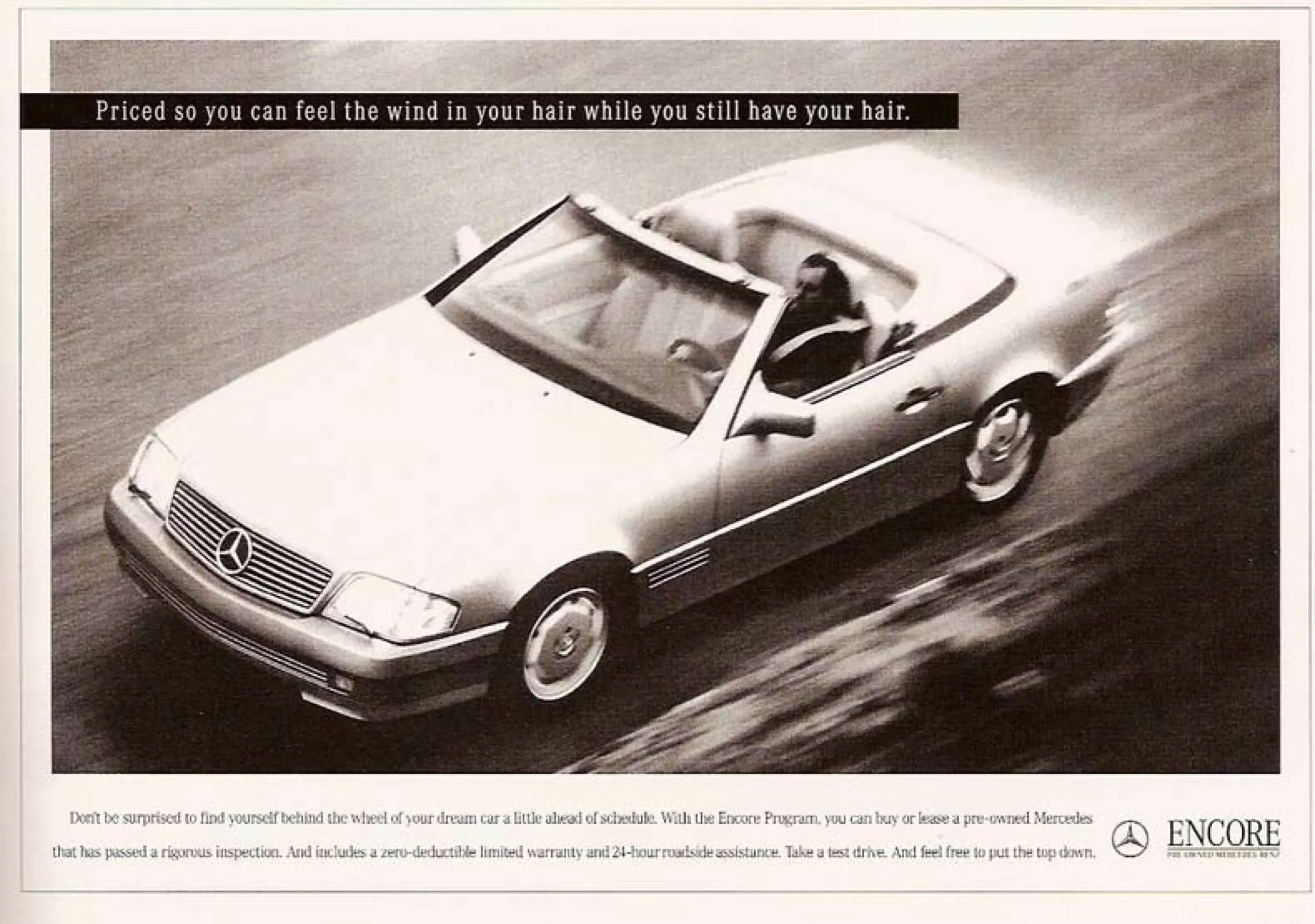 A black and white print ad of a Mercedes-Benz convertible driving fast, under the line "Priced so you can feel the wind in your hair while you still have your hair."